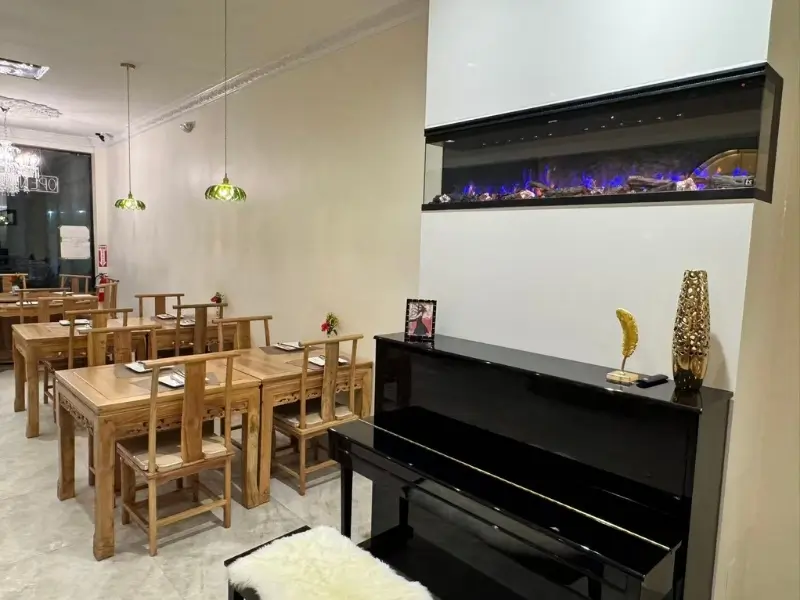 Area with a black piano and decorative items at Silver Spring Sichuan Bistro, a Chinese Restaurant in Silver Spring